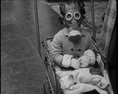 A Young Child in a Pram Wearing a Gas Mask, 1939. Creator: British Pathe Ltd.
