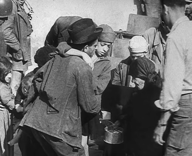 Italian Civilians Getting Assistance from American Soldiers in a Bomb-Damaged Italian Town, 1943-44. Creator: British Pathe Ltd.