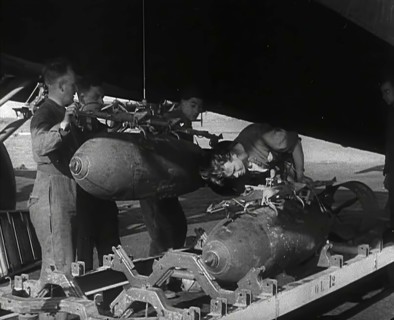 RAF Ground Crew Members Fixing Bombs to an Avro Lancaster Bomber, 1942. Creator: British Pathe Ltd.
