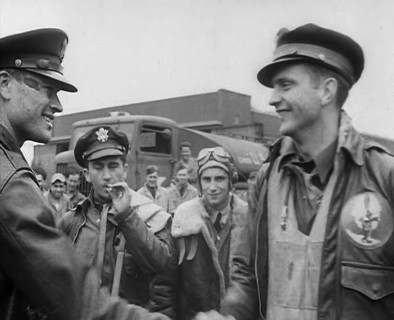 A Male Pilot Shaking Hands with an Officer, whilst other Pilots are Looking On, 1943-1944. Creator: British Pathe Ltd.