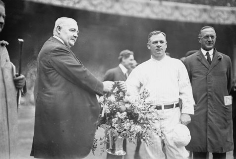 Edward McCall presents a silver basket of flowers to New York Giants manager John McGraw..., 1913. Creator: Bain News Service.
