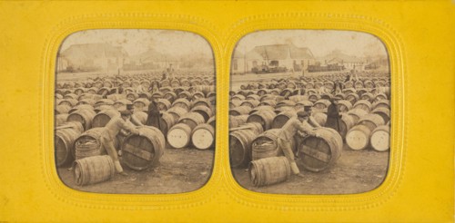 Men rolling a barrel in a field of barrels, 1860s. Creator: E Lamy.