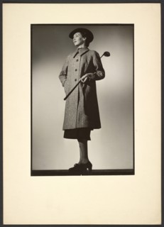 Woman modeling coat with golf club, early 1940s. Creator: Gunther Krampf.