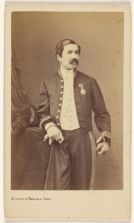 Unidentified man with moustache standing, wearing a medal on his lapel, about 1861. Creator: Bayard & Bertall.