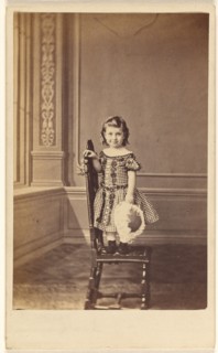 Little girl standing on a chair, 1865-1875. Creator: Frederick Downer & Sons.