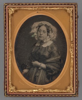 Portrait of a middle-aged woman wearing wire-rimmed glasses in flower embellished veil, 1855-1860. Creator: James McClees.