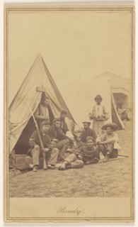 Group of seven soldiers and one black servant at a campsite, about 1862. Creator: Mathew Brady.