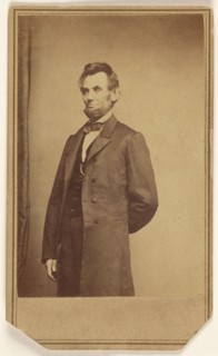 Abraham Lincoln standing with one arm behind his back, about 1864. Creator: Studio of Mathew B. Brady.
