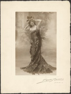 Woman wearing headdress with grapes, about 1890. Creator: Henri Mannes.