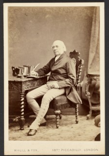 Portrait of man holding quill, about 1879-1885. Creator: Maull & Fox.