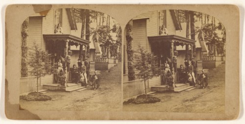 Family portrait posed on front porch of house, about 1865. Creator: Unknown.