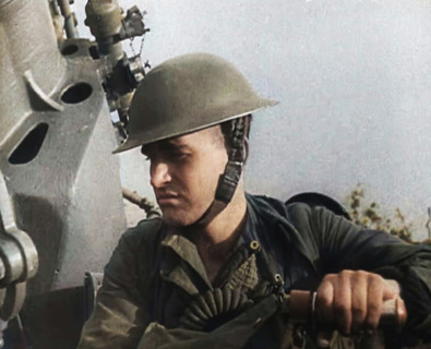 Close up of a Male British Soldier Wearing a Steel Helmet and Sitting Next to an Anti-Air..., 1939. Creator: British Pathe Ltd.