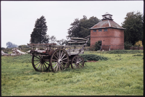 The dovecote to the south-west of Kentwell Hall seen with an old wooden wagon in the foreground,