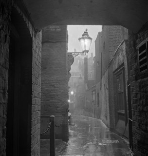 A dimly lit alley in London's theatre land off St Martin's Lane, early 1960s. Image featured in
