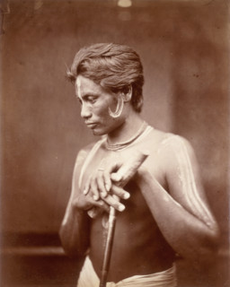A Manipuri Polo player, 1860. This man from Manipur has face and body paint, and holds a polo stick