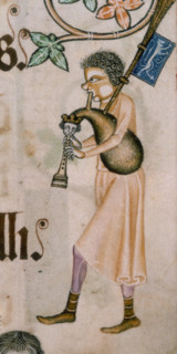 A bagpiper, c1300-c1340. His cheek is puffed out with the effort of playing the instrument. The