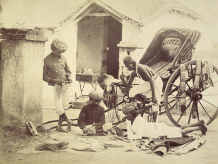 Four men and a rickshaw, India, 1873. Two are playing cards. The man on the right holds a chillum,