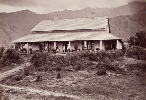 Tea estate bungalow at Sumali, 1860s. European man and children on the verandah, with Indian