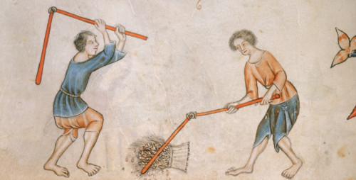 Two men beating corn with flails, c1325-c1335. Two barefoot men with flails thresh a sheaf of corn.