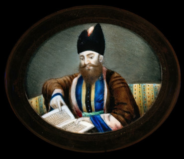 An Indian (?) man seated, reading a book. Creator: Unknown.