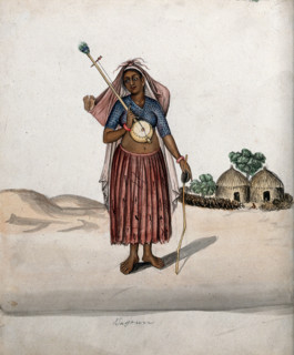 A village woman carrying a musical instrument in one hand, a stick with..., (between 1800 and 1899?) Creator: Unknown.