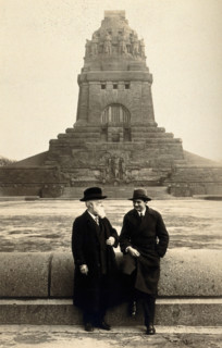 Georg Sticker and an unknown companion, in front of a war memorial (?). Creator: Unknown.