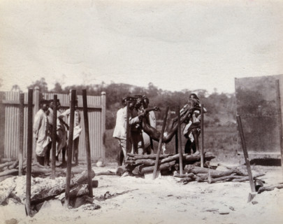A group of men lower the body of a dead man on to a pyre of logs prior to a Hindu...,  1896/1897. Creator: Unknown.