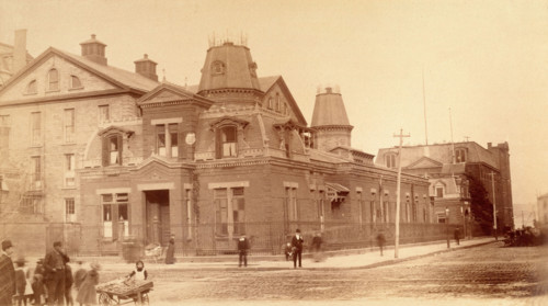 Bellevue Hospital, New York City: a street corner with hospital buildings and people, 1885-1898. Creator: Unknown.