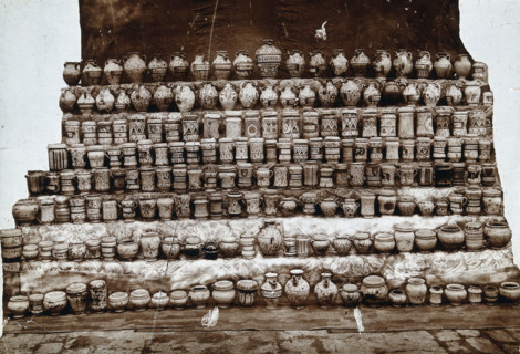 Rows of decorated pharmacy jars and other objects, c19th century. Creator: Unknown.