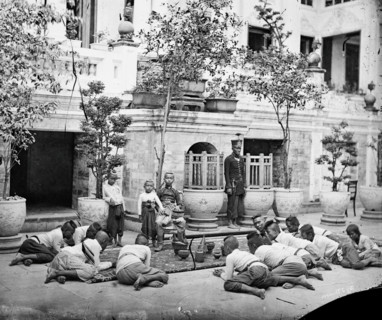 Prince Chulalongkorn of Siam [Thailand] (seated, centre), with Prince Bhanugrangsi Savan..., 1866. Creator: John Thomson.