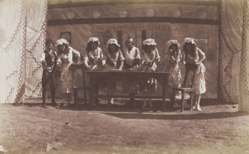 British servicemen in drag acting out a cooking class, 1918. Creator: Unknown.