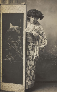 A man wearing a kimono posing from behind a screen, 1906. Creator: Unknown.