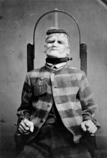 Wakefield Prison, Yorkshire: an elderly man, struggling against the restraint-chair in..., c1869. Creator: Unknown.