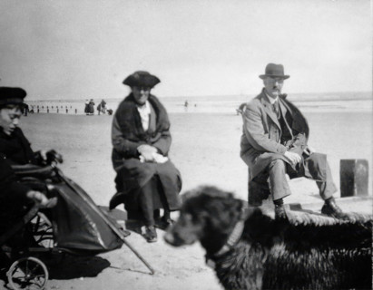 A physically disabled boy sitting in a wheelchair on a beach,  c1910/1925. Creator: Unknown.