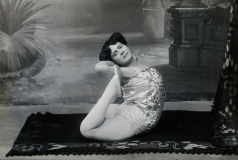 A Bulgarian female acrobat performing contortions in a photographic studio, between 1890 and 1910. Creator: Unknown.