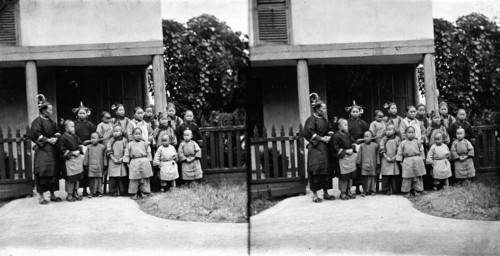 Fukien province, China: women and children outside a school (?), 1871. Creator: John Thomson.