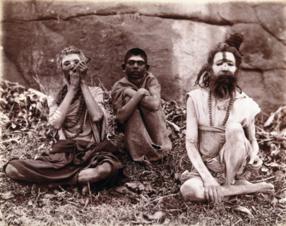 Two men and a boy sitting cross-legged on the ground surrounded by leaves; their faces...  1896/1897 Creator: Unknown.