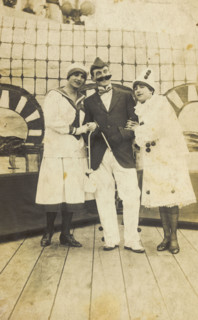 Three sailors, two in drag wearing pierrette costumes, pose on deck, c1910s. Creator: Unknown.
