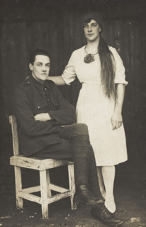 Two prisoners of war, one in drag, pose with a chair, [between 1910 and 1919?]. Creator: Unknown.