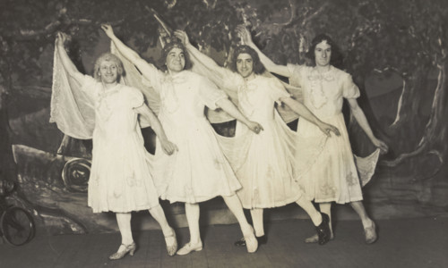 Amateur actors in drag, wearing white dresses and dancing on stage, [between 1910 and 1919?]. Creator: Unknown.
