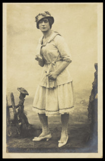 An actor, in drag, performing English theatre at a prisoner of war camp in Cottbus, [1910-1919?]. Creator: Unknown.
