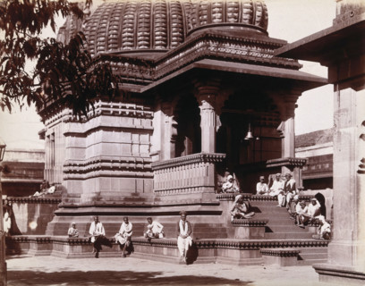 Indian men sitting on steps outside a domed building in Bombay during an outbreak of plague, 1896/7. Creator: Unknown.