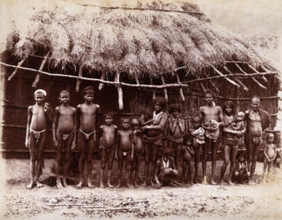 A group of adults and children standing in a line outside a bamboo hut with a thatched..., 1896/1897 Creator: Unknown.