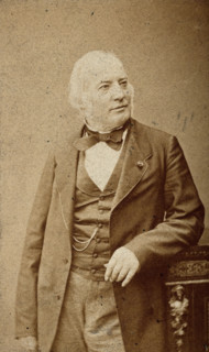 An unidentified man leaning on a cabinet, c1880s. Creator: Frederick Mulnier.
