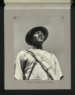 A gunner of the Sudan Artillery Regiment, 1964. Creators: Colonial Office, Unknown.