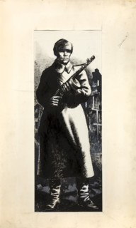 Russian infantryman, standing amidst ruins of town, between 1939 and 1946. Creators: Central Office of Information, Unknown.