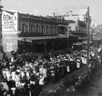 Procession of girls and women out the front of 142, Queen Street corner Edward Street, 1905. Creator: Robert Augustus Henry L'Estrange.