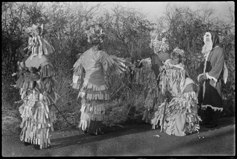 A group of people in costume performing in a Mummers' play, Andover, Test Valley, Hampshire, 1948. Creator: George R Long.