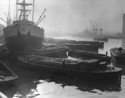 Barges and cargo ships on the River Thames, Pool of London, 1950s. Creator: Arthur Charles Kirby Ware.