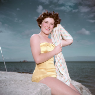 Portrait of a young woman in a swimsuit by the sea, c1955. Creator: Arthur Charles Kirby Ware.